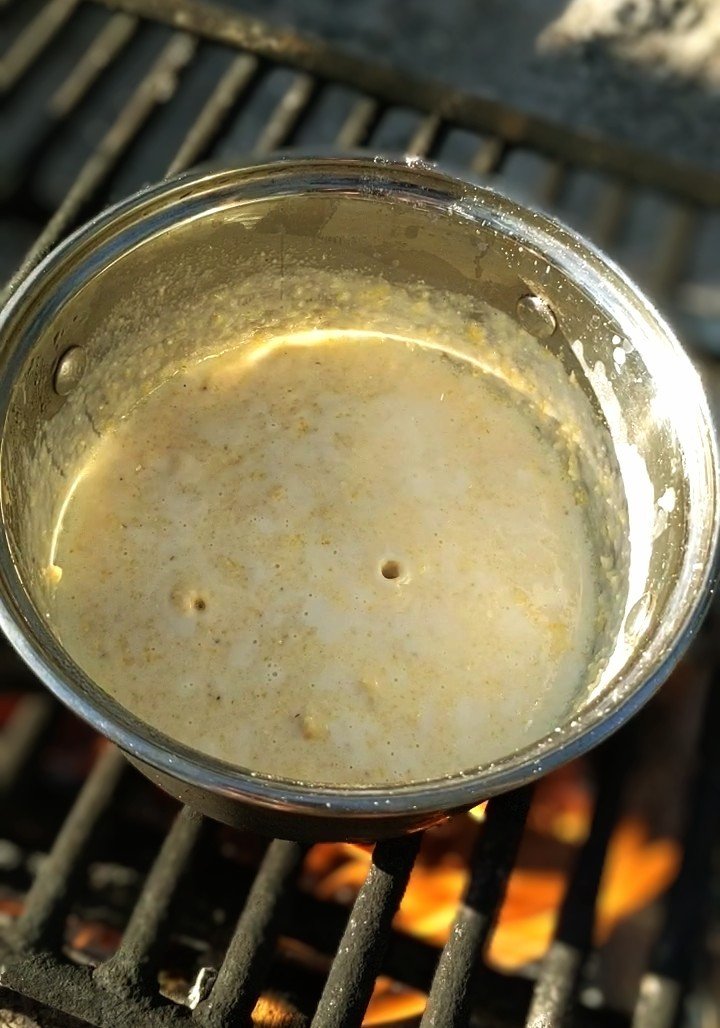 polenta thickening and bubbling over a campfire