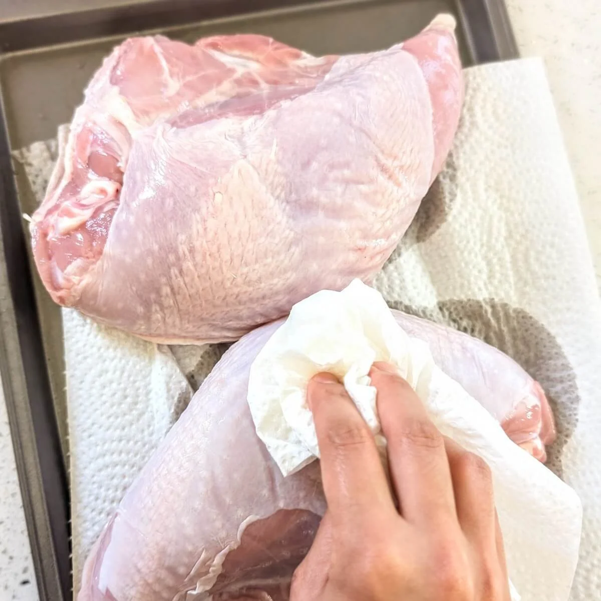 Patting raw turkey breasts dry with a paper towel before brining