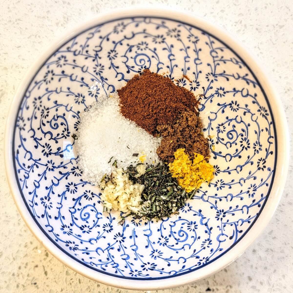 Turkey dry brine ingredients in a white bowl on a countertop