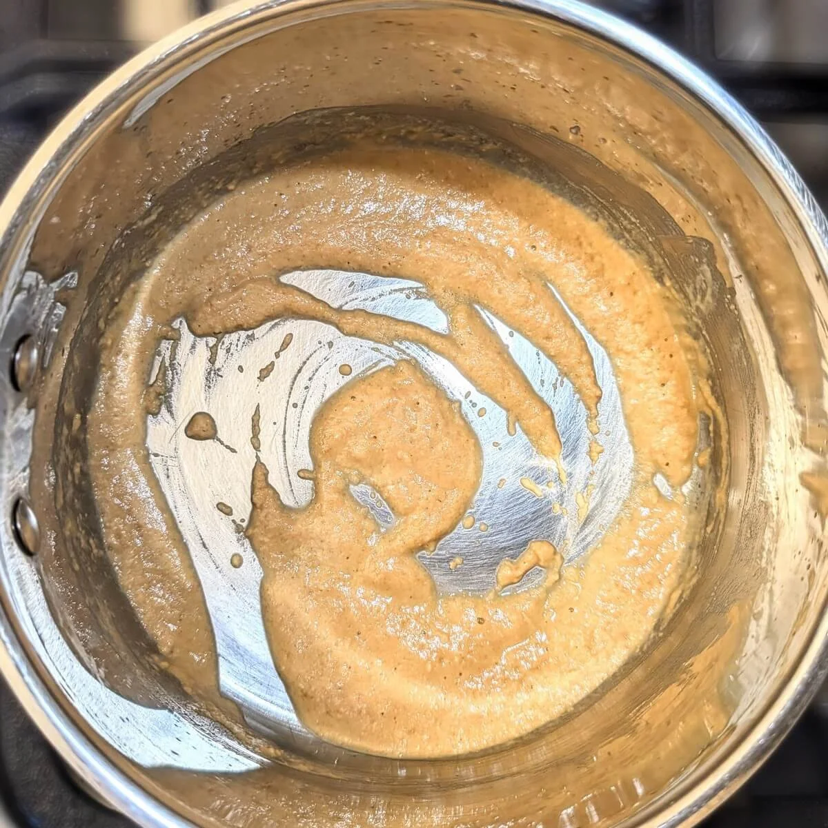 Cooked roux turning golden brown in a pan for turkey gravy