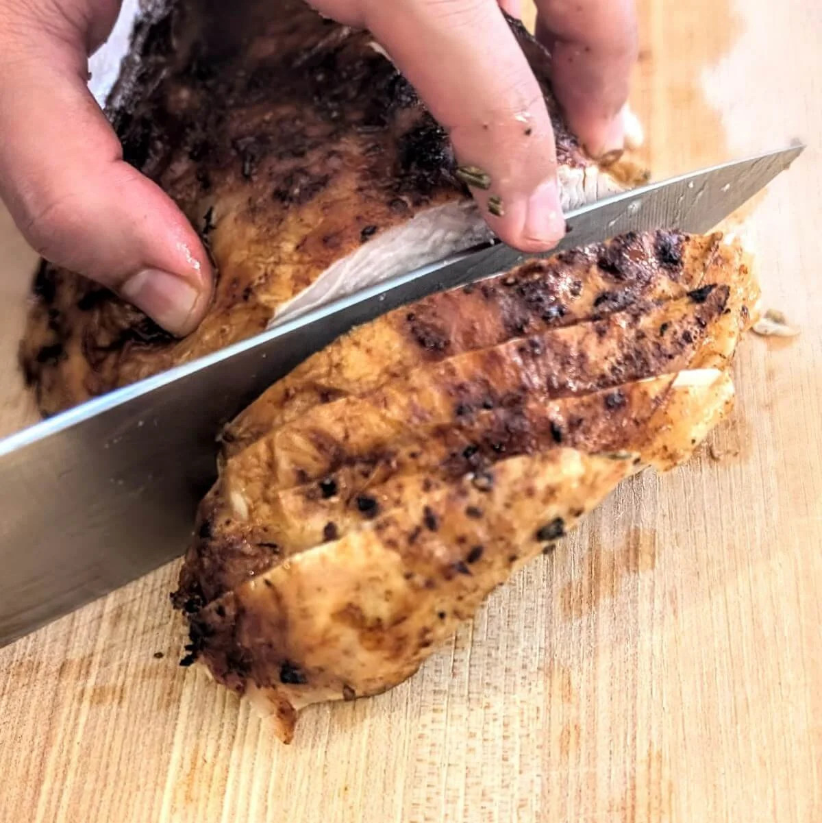 Slicing boneless turkey breast into even pieces for serving