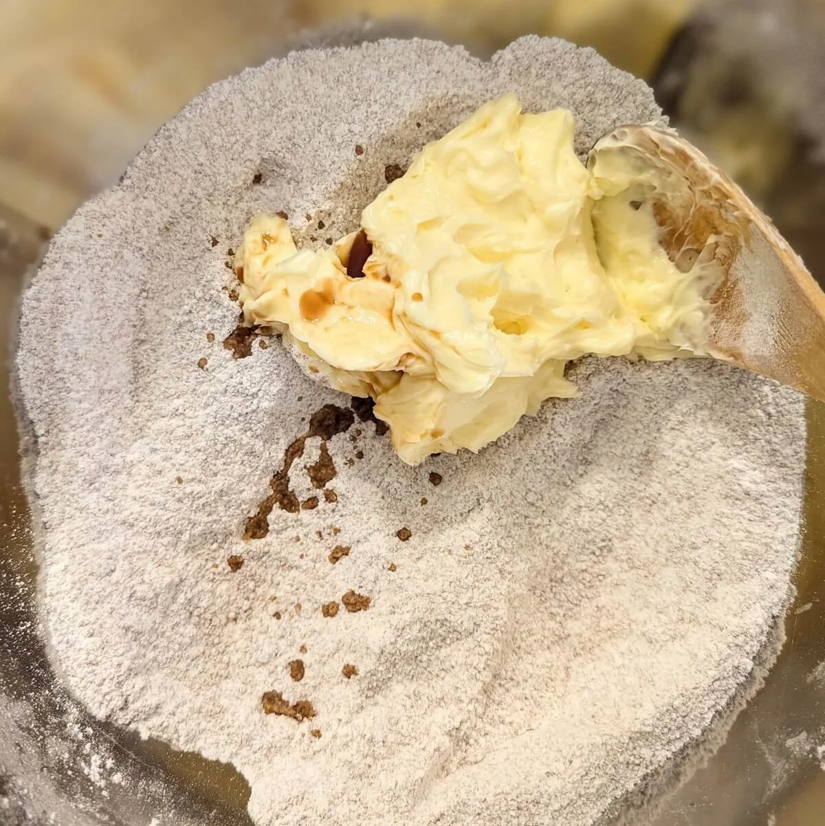 Softened butter and vanilla added to bowl for chewy dark chocolate chip cookies