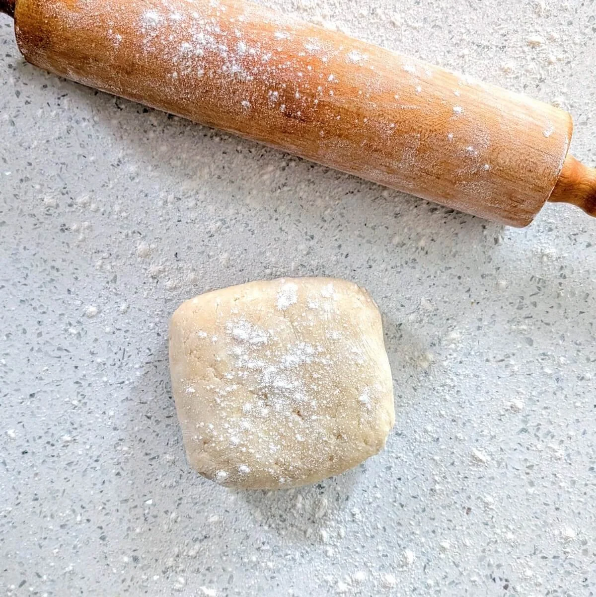 Floured pie dough on a floured surface, ready to roll for homemade pumpkin pie crust