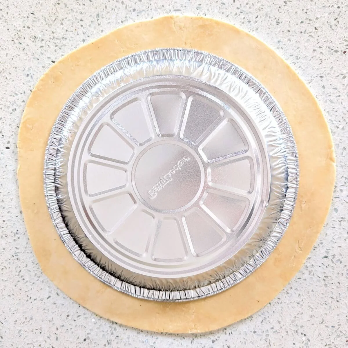 Trimmed pie dough with a 1-inch overhang, perfect for flaky homemade pie crust