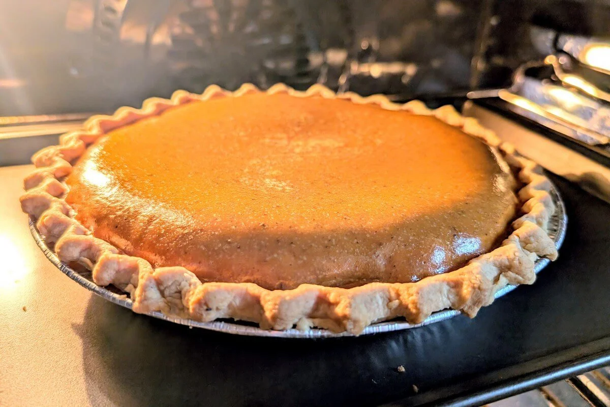 Baked pumpkin pie with set custard filling and golden flaky crust