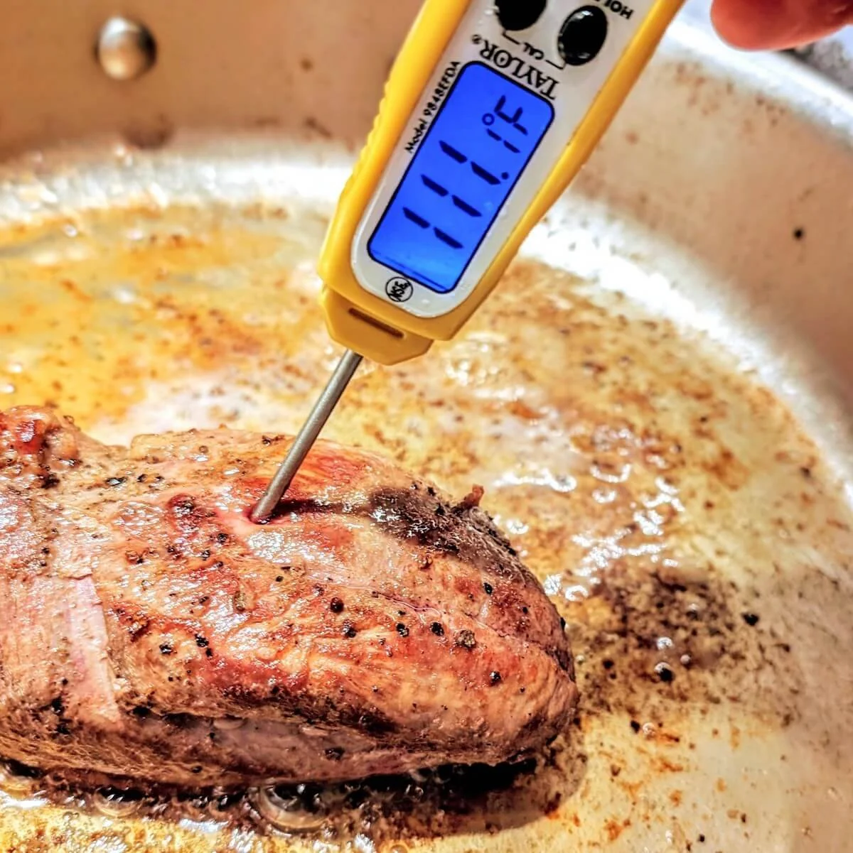 Checking internal temp of pan seared duck breast with instant-read thermometer