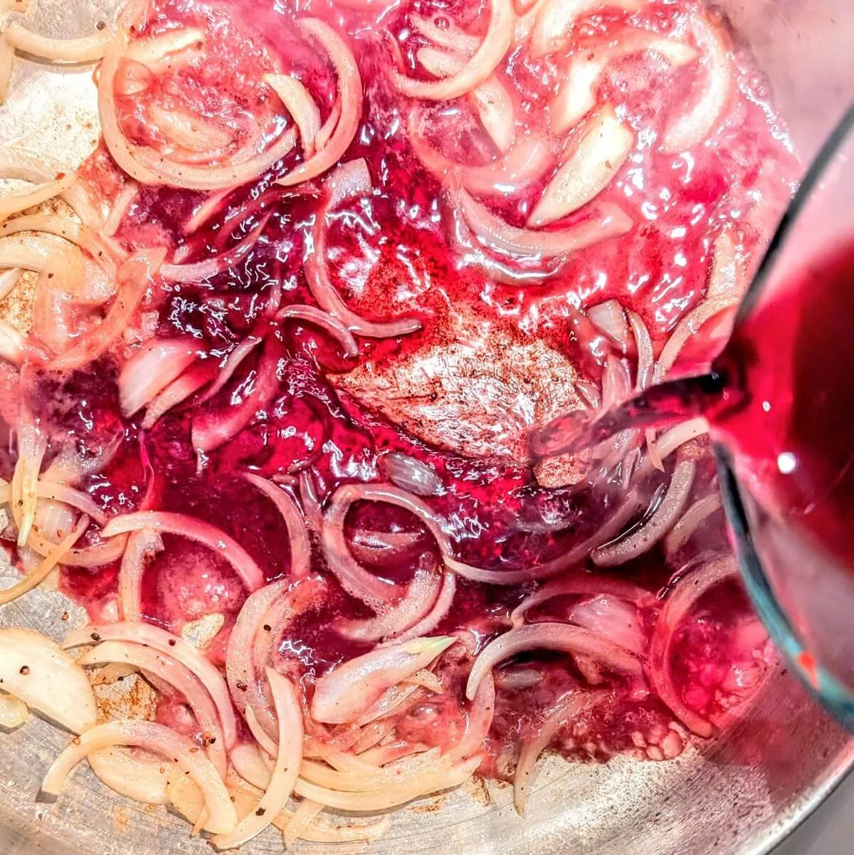 Deglazing pan with red wine and onions for duck breast pan sauce