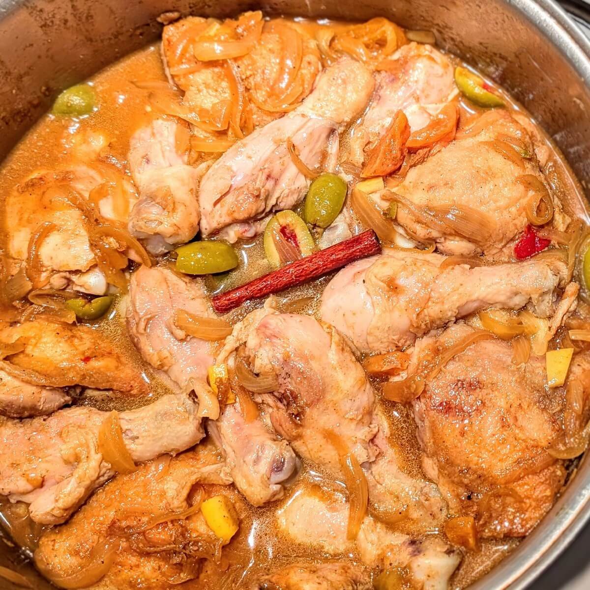 Chicken thighs layered into the pot to simmer in authentic chicken tagine with preserved lemons