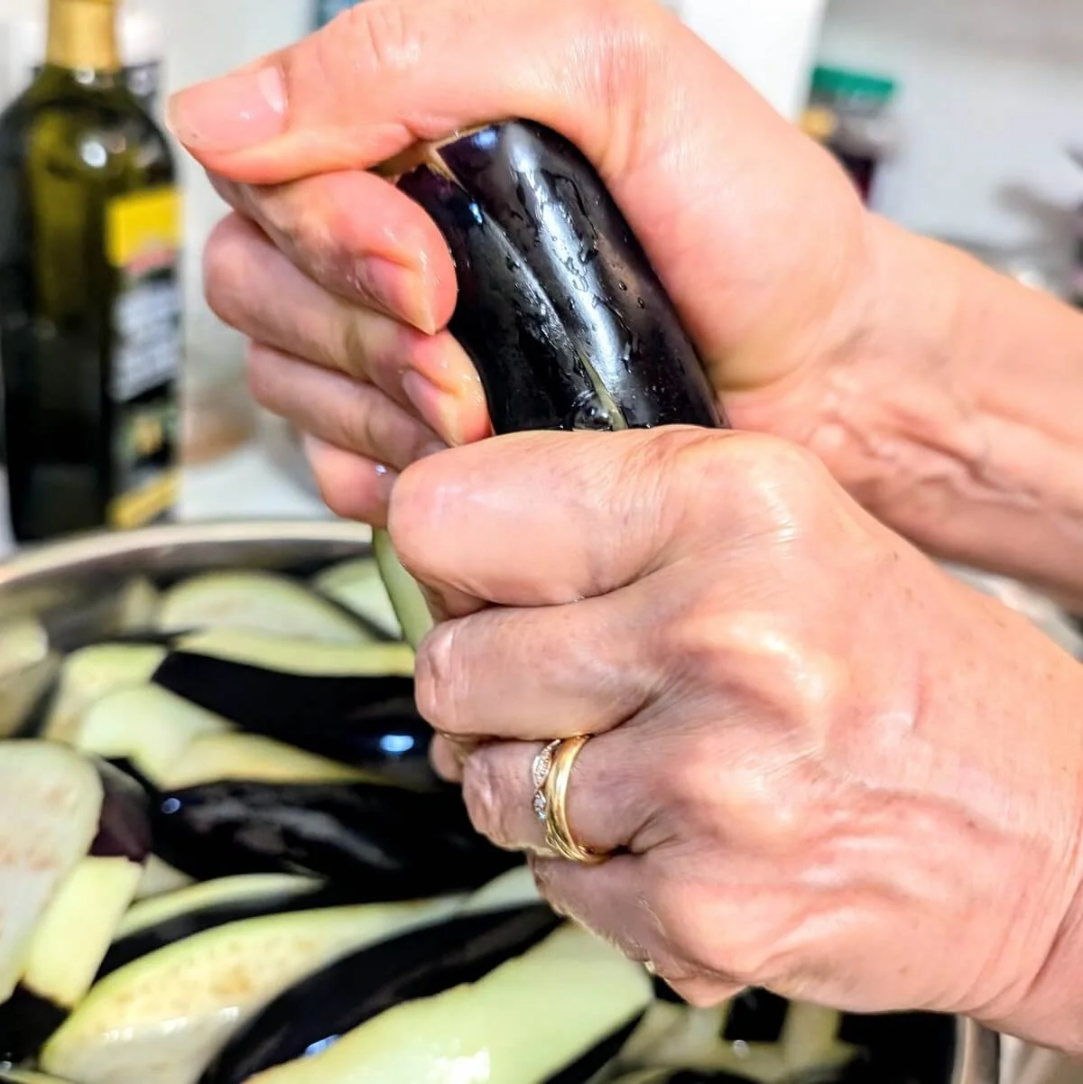Hand gently squeezing brined eggplant before searing
