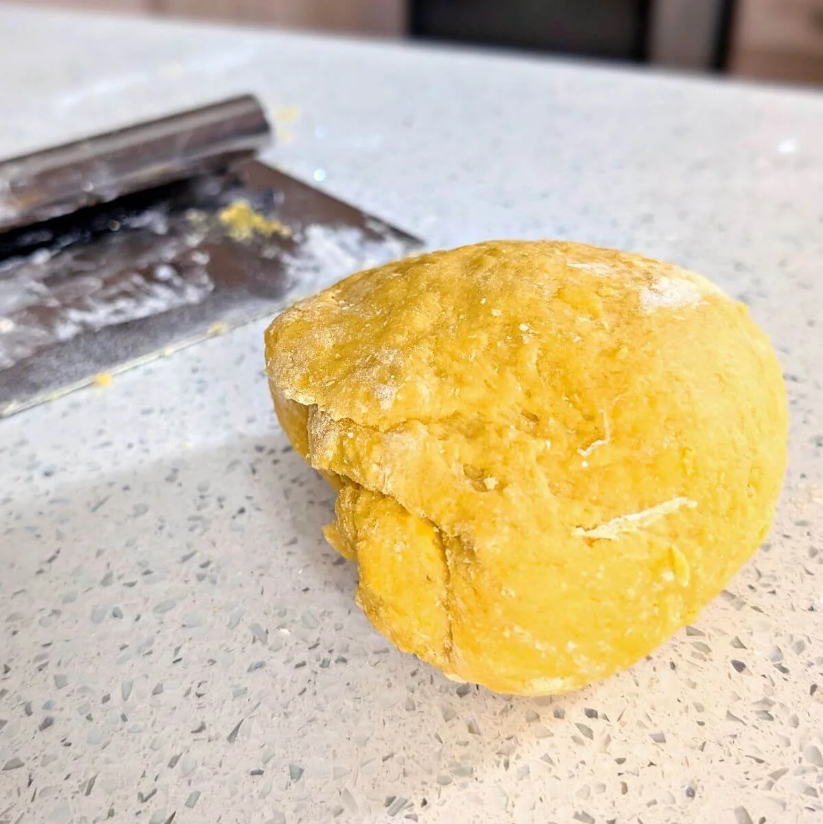 Cohesive ball of pasta dough ready for full kneading