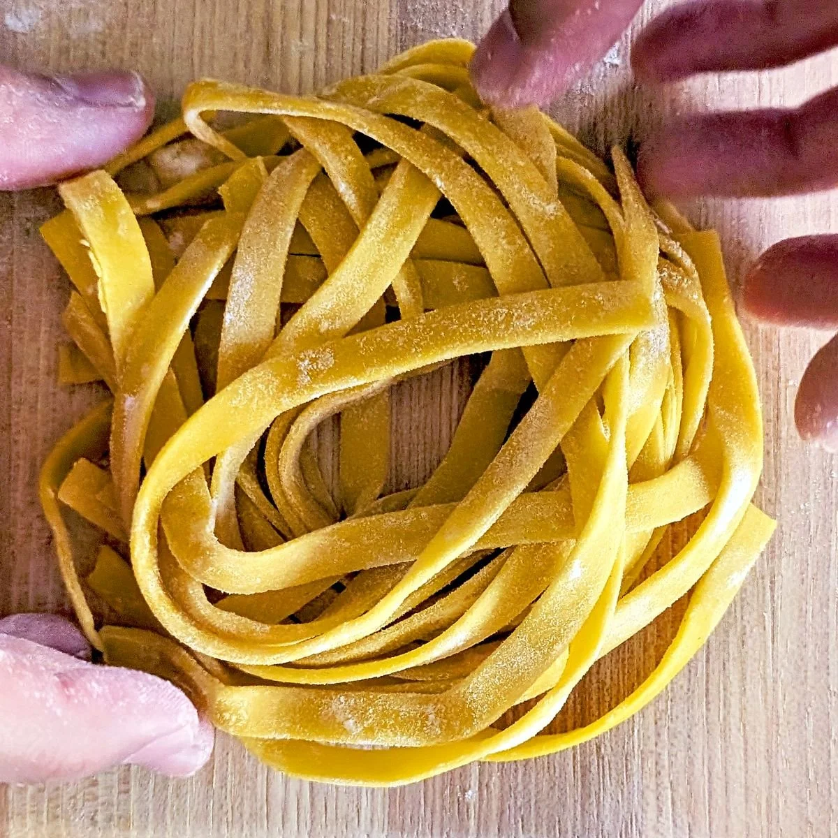 Fresh pasta shaped into a loose nest and lightly dusted with flour