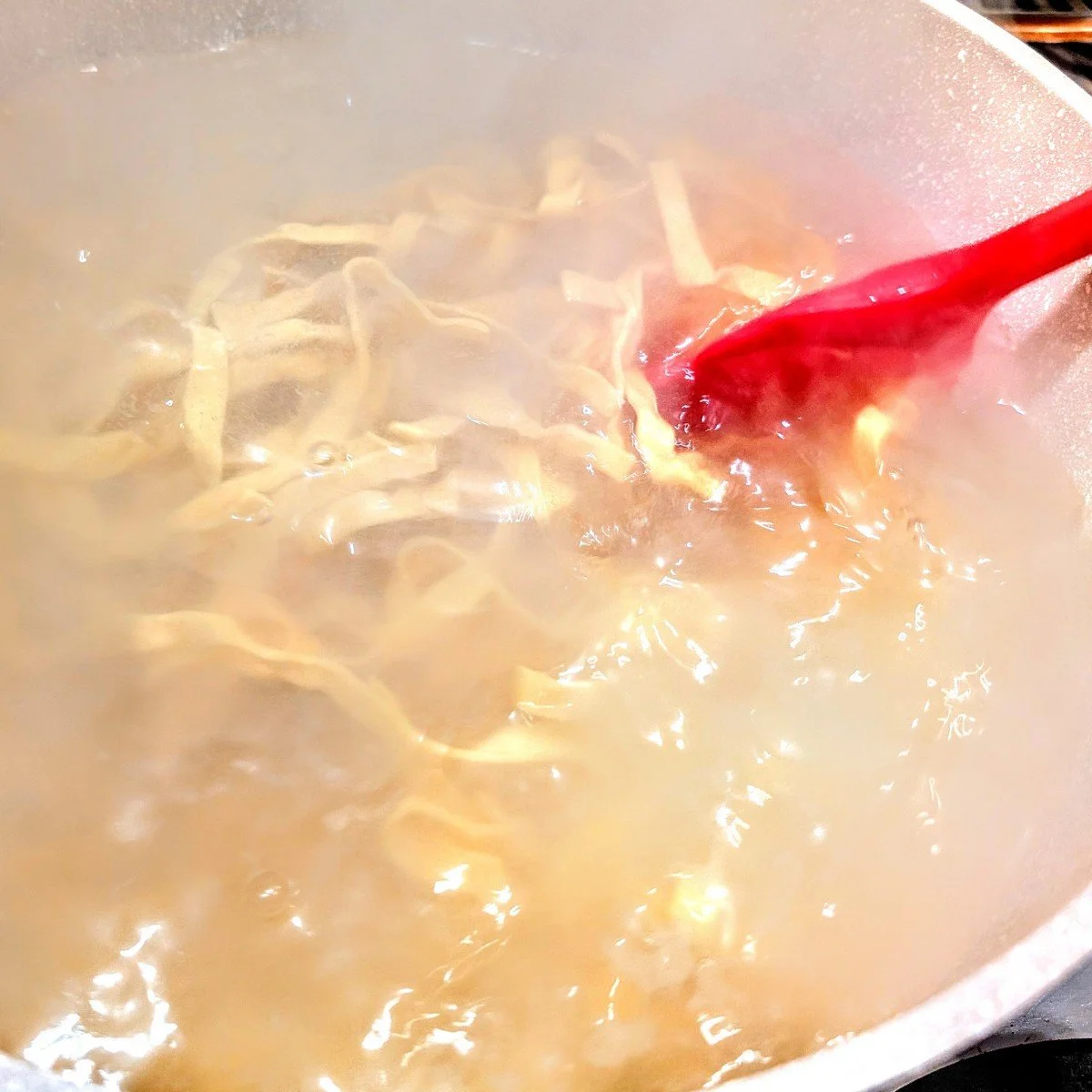 Fresh pasta cooking in salted boiling water