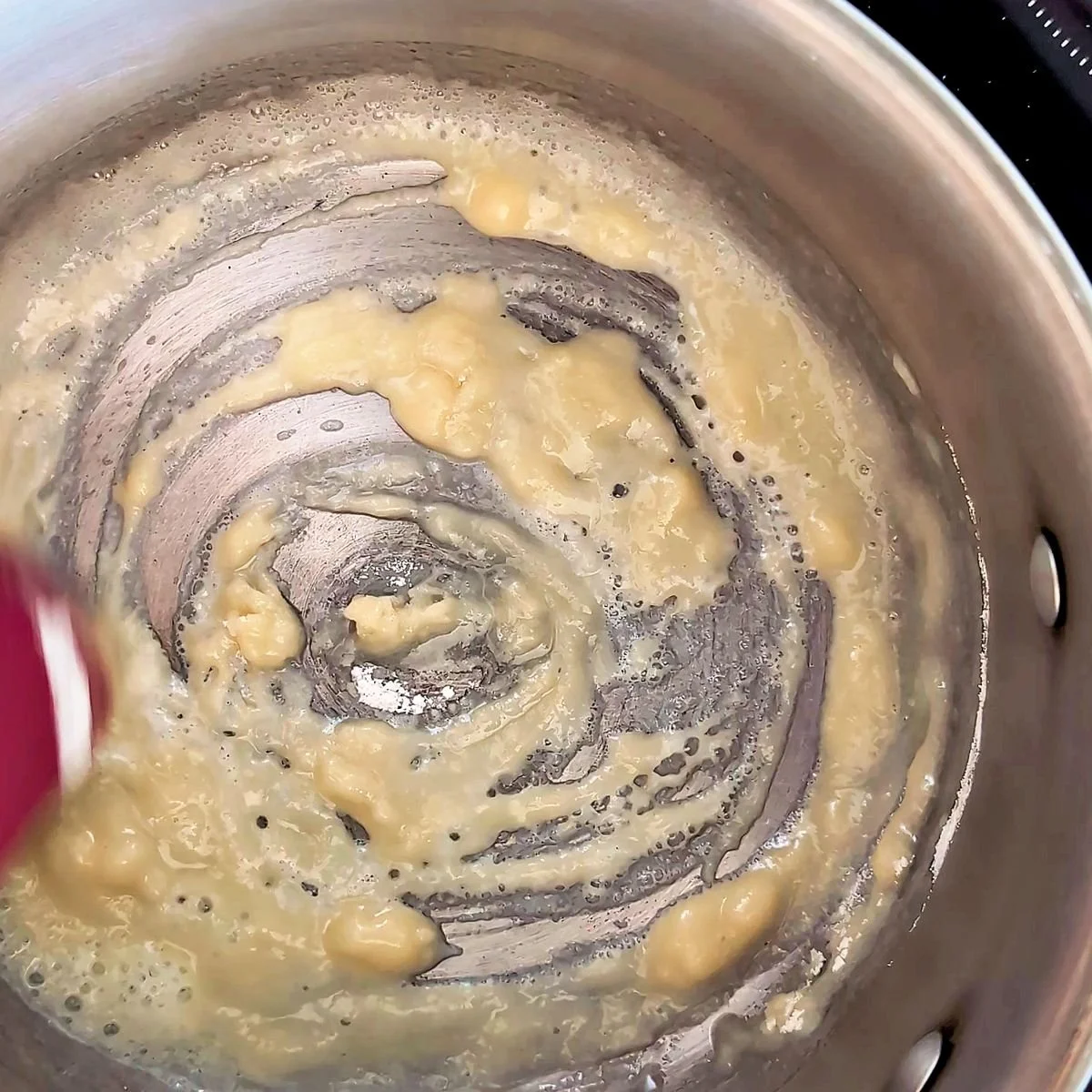 Cooking a white roux until smooth for classic mornay sauce