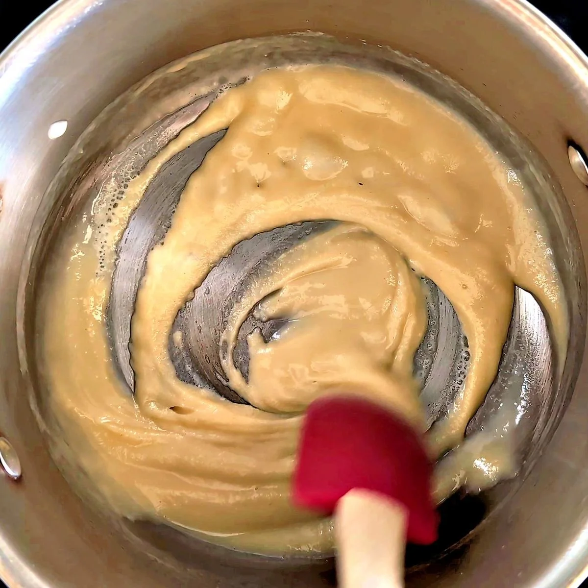 Blond roux stirred until smooth for homemade velouté sauce