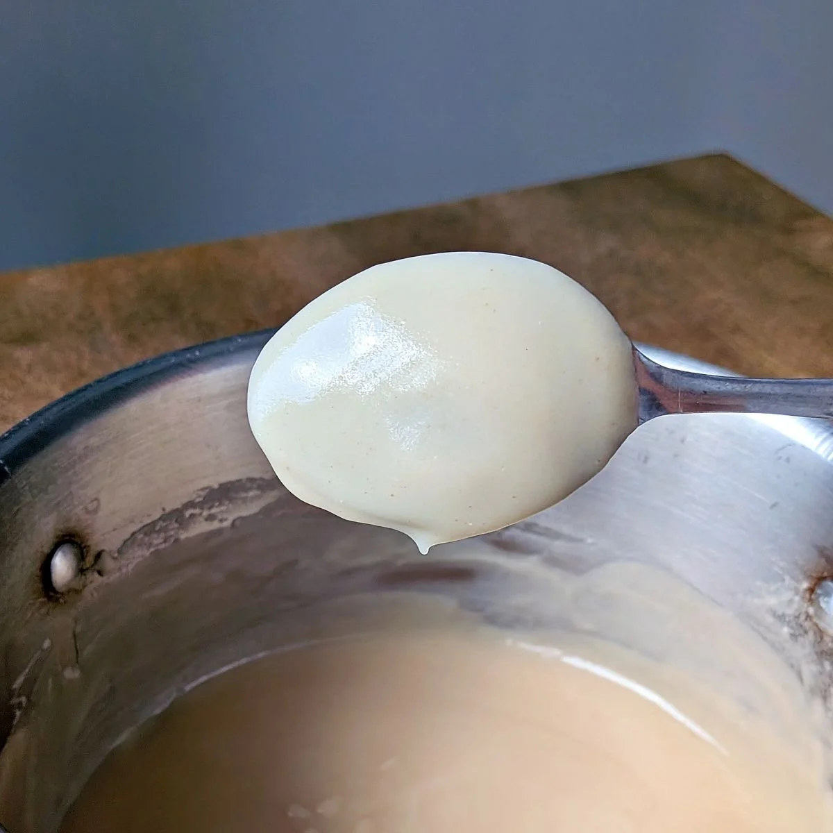 Velouté sauce coating the back of a spoon for the nappé test
