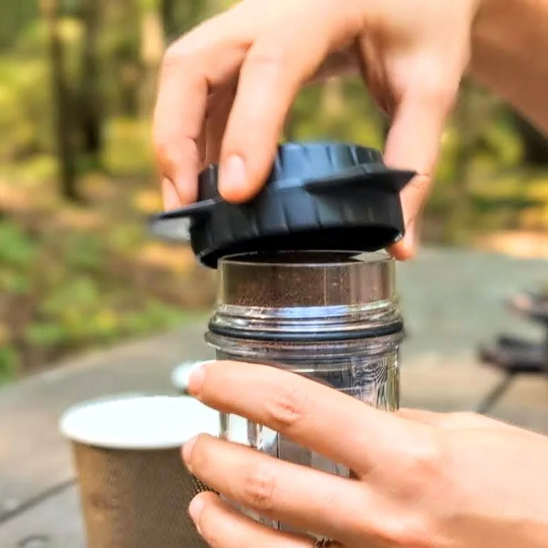 Screwing on the Delter filter cap onto the coffee chamber