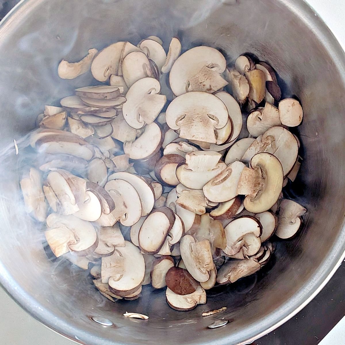 Cremini mushrooms cooking for vegetarian mushroom gravy