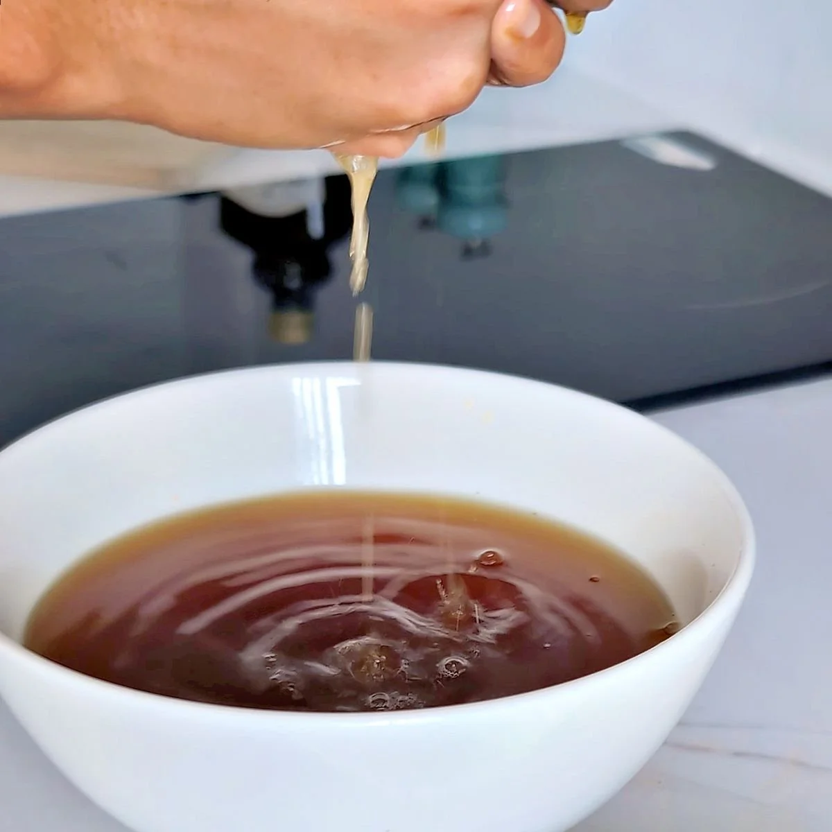Squeezing rehydrated shiitake mushrooms for the gravy