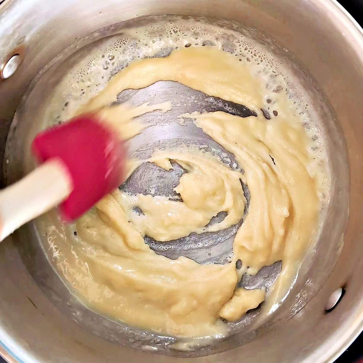 Stirring a white roux as it cooks