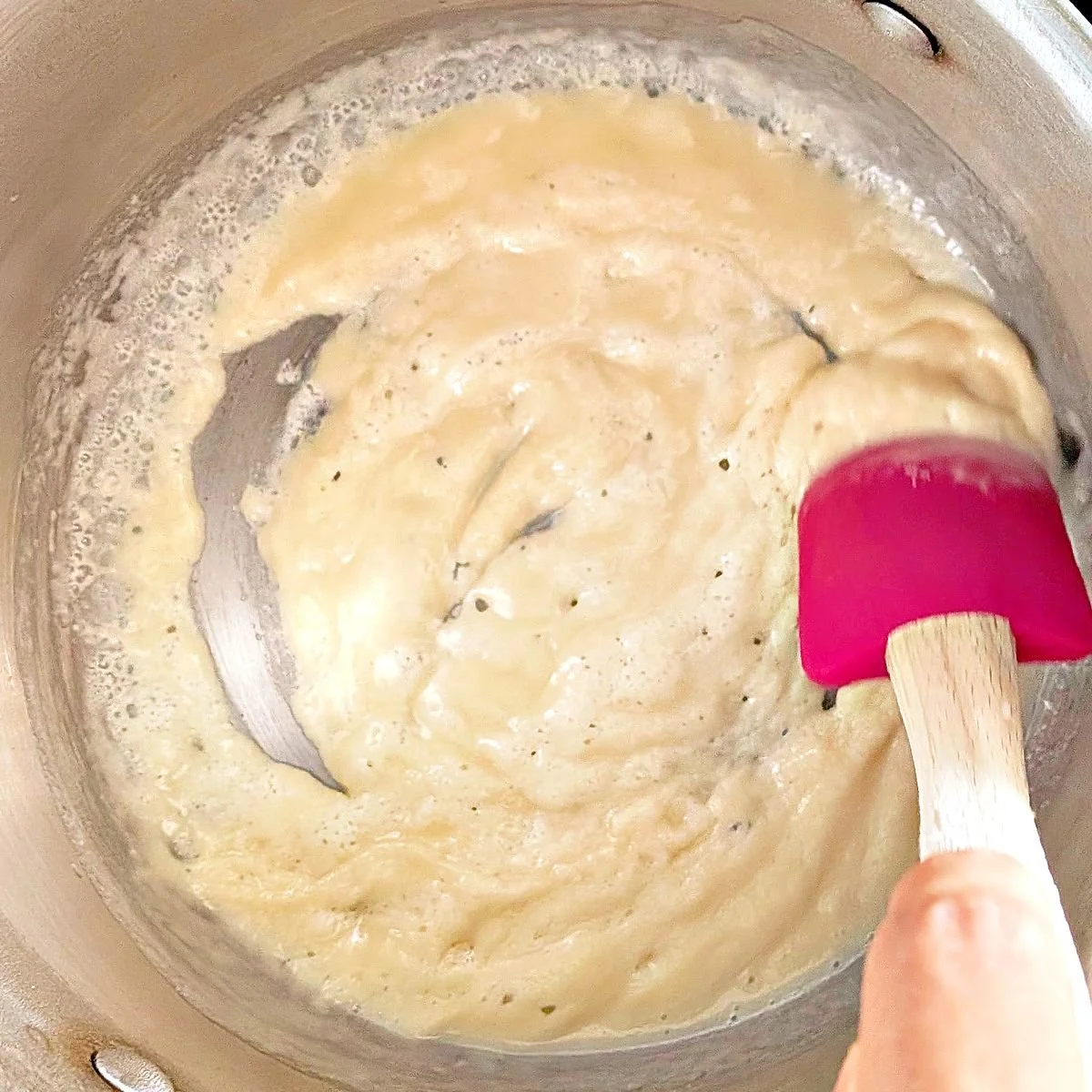 Smooth white roux cooking in a saucepan