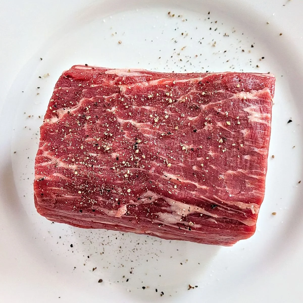 Seasoned beef tenderloin before searing for beef Wellington