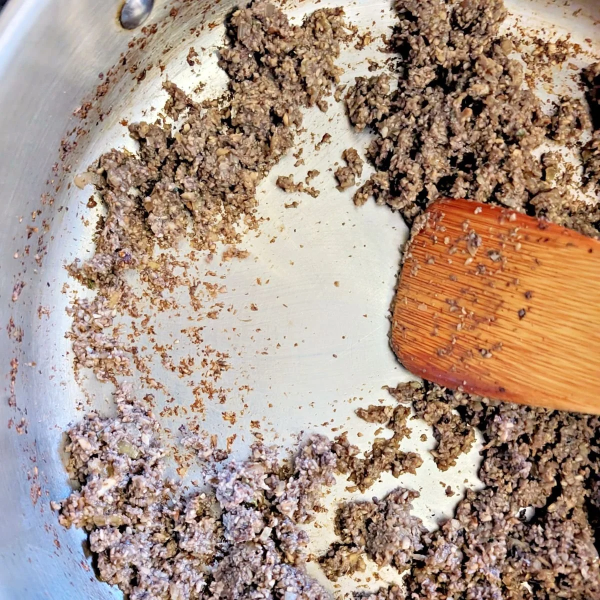 Mushroom duxelles cooked until dry and beginning to catch on the pan