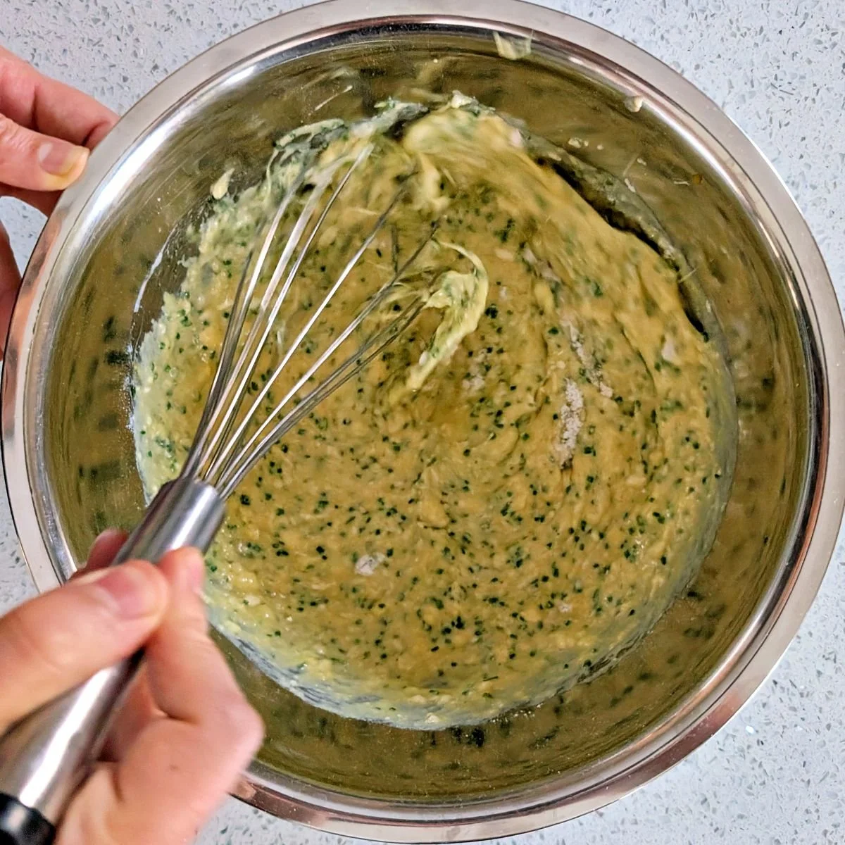 Whisking the chive crêpe batter until smooth