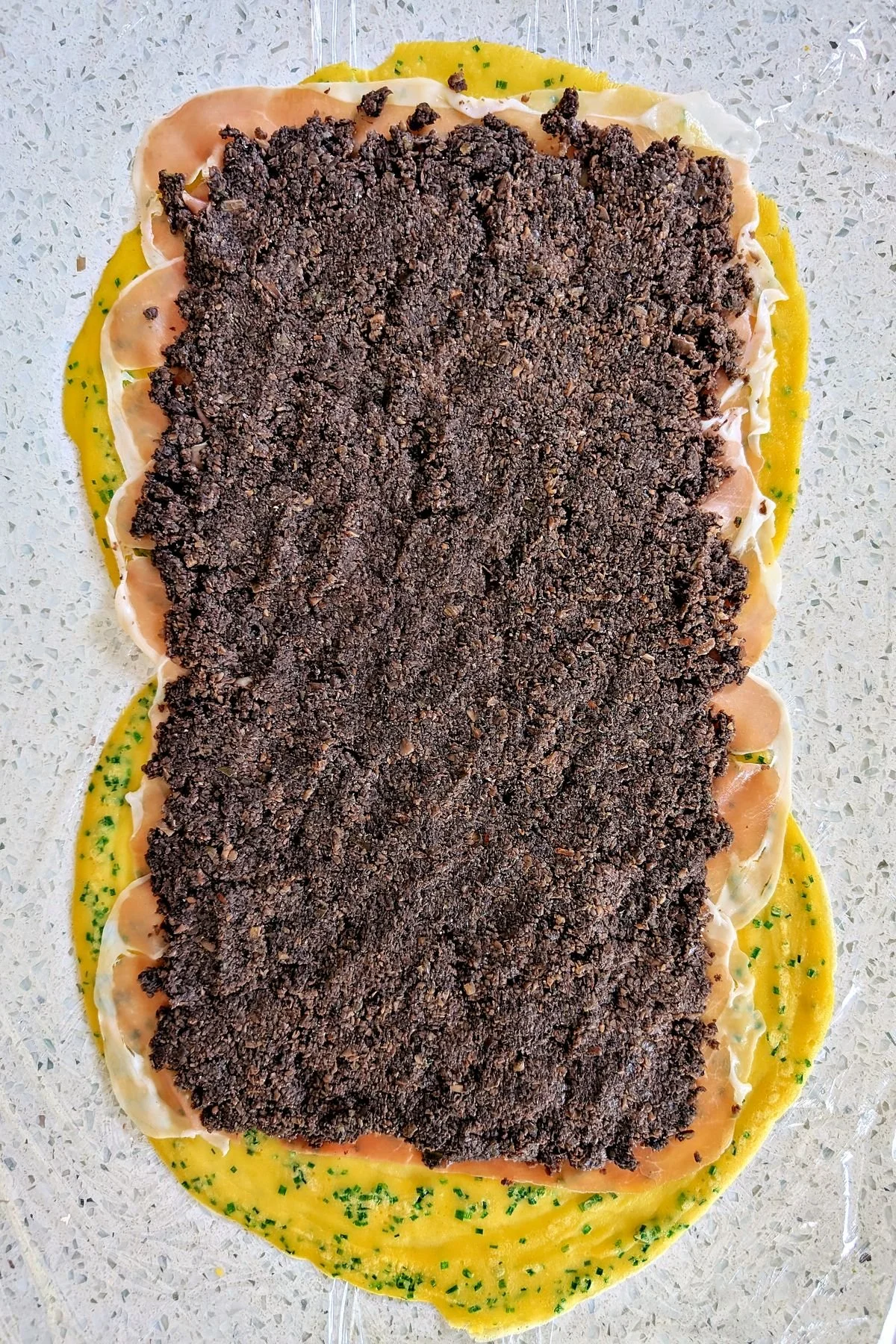 Even layer of mushroom duxelles ready for wrapping the beef tenderloin