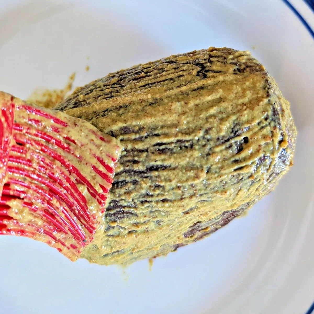 Dijon mustard brushed over the seared beef tenderloin