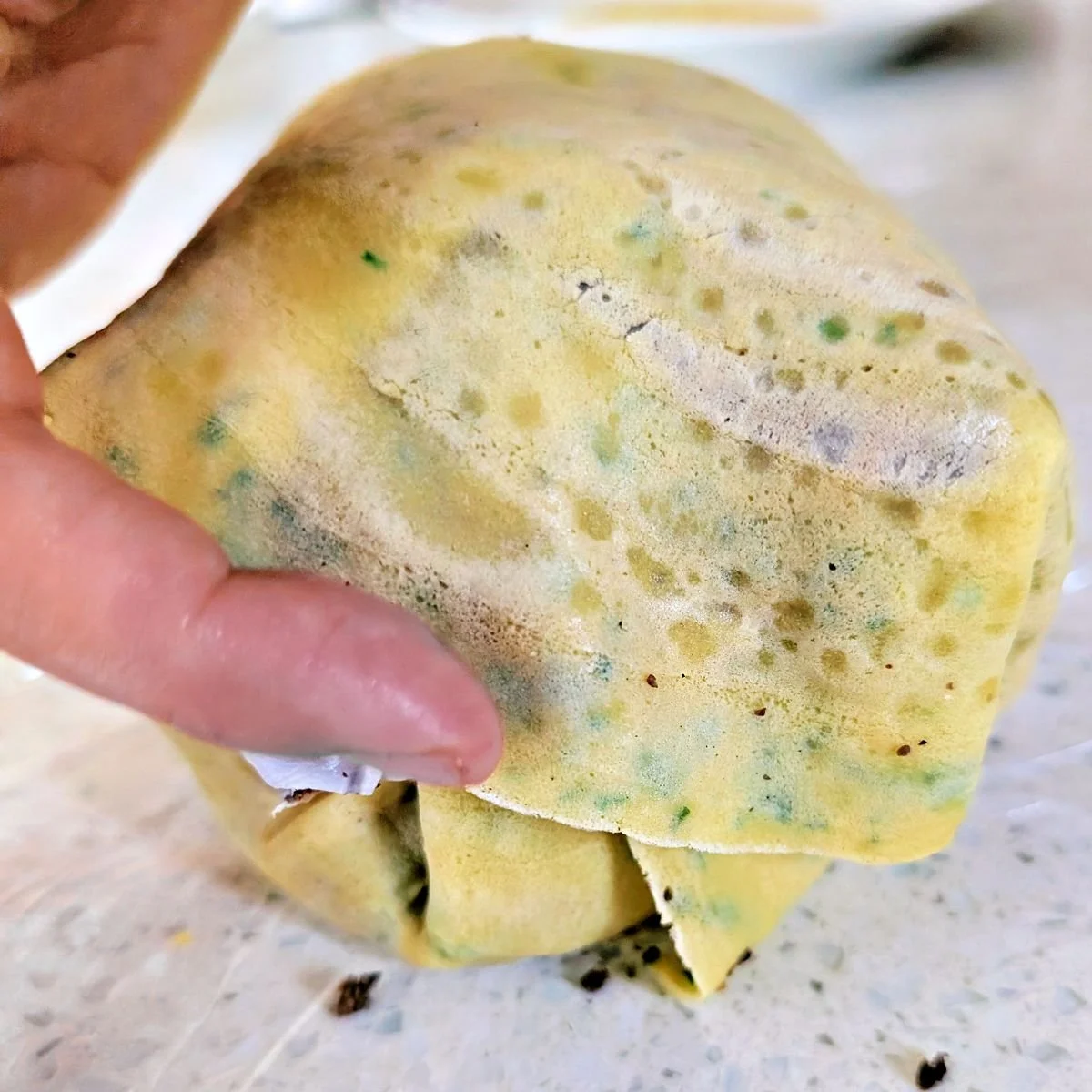 Crêpe edges pressed together to fully enclose the beef