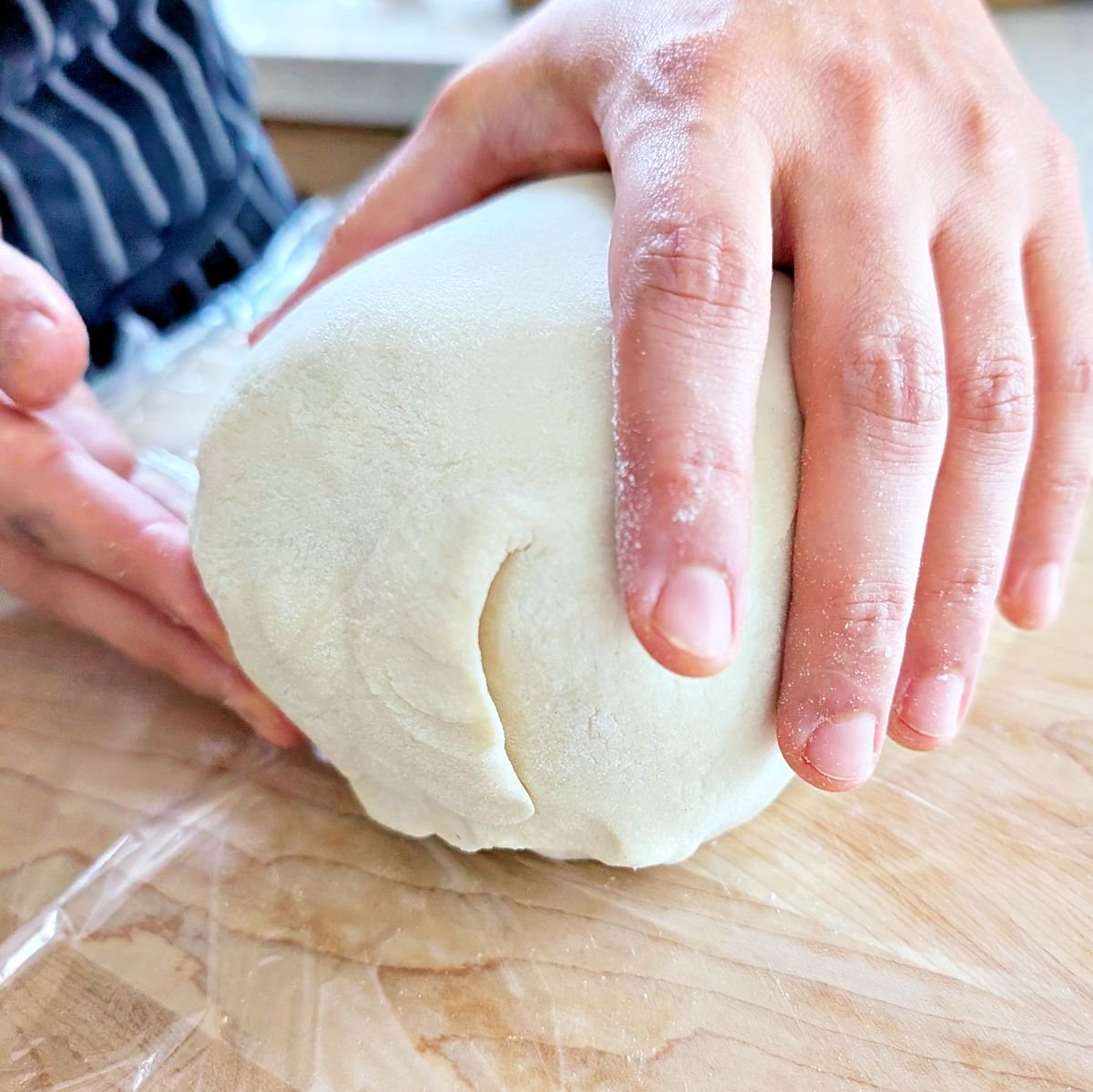 Puff pastry pressed together to seal the end of the beef Wellington