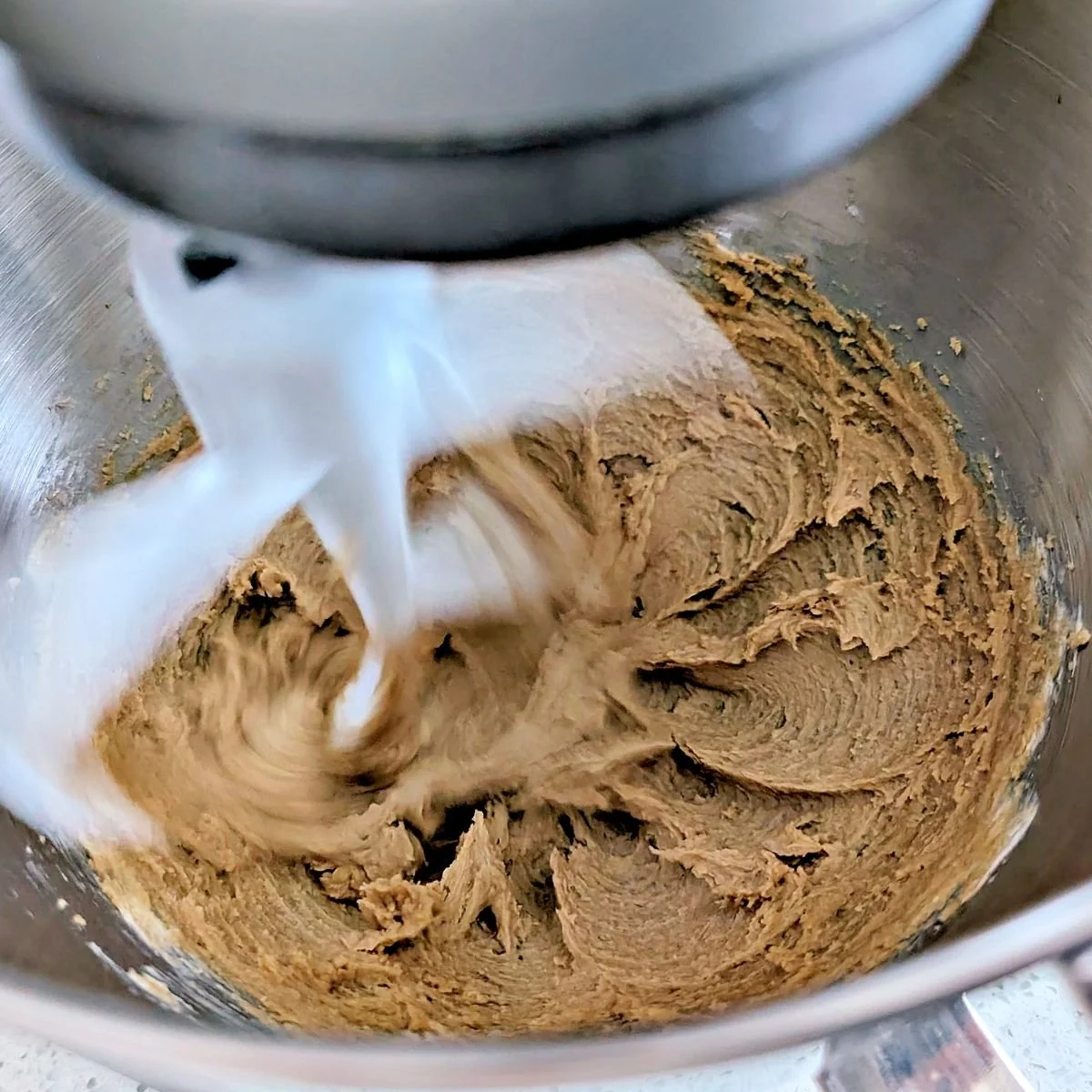 Butter and brown sugar mixing in a stand mixer