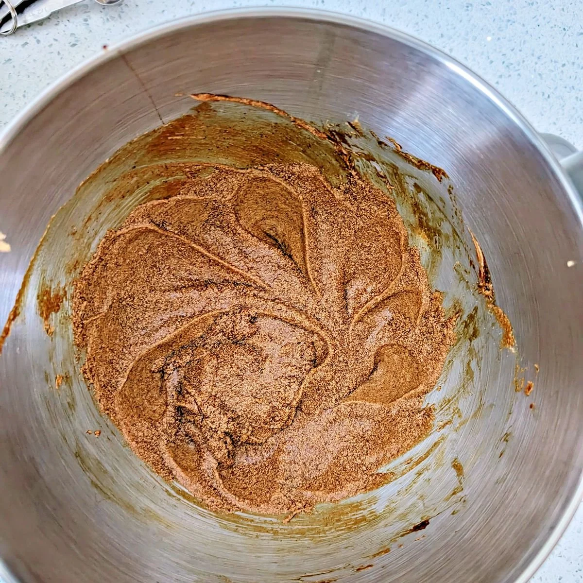 Ground spices, egg, and molasses mixed into the butter and brown sugar