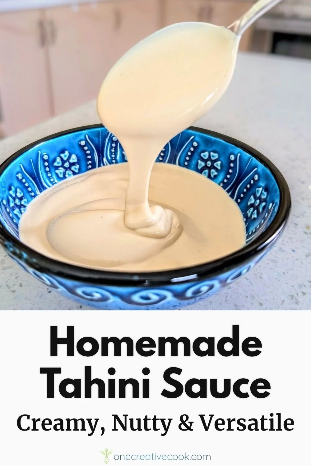 Homemade immersion blender tahini sauce drizzling off of a spoon into a bowl