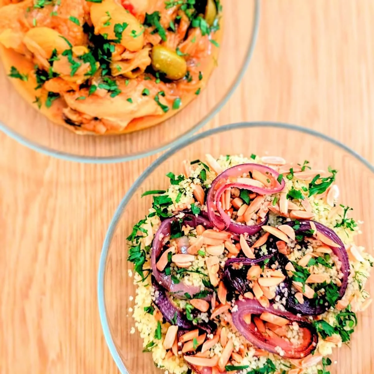Kettle couscous with onions, almonds, herbs, and preserved lemon vinaigrette served next to a bowl of chicken tagine