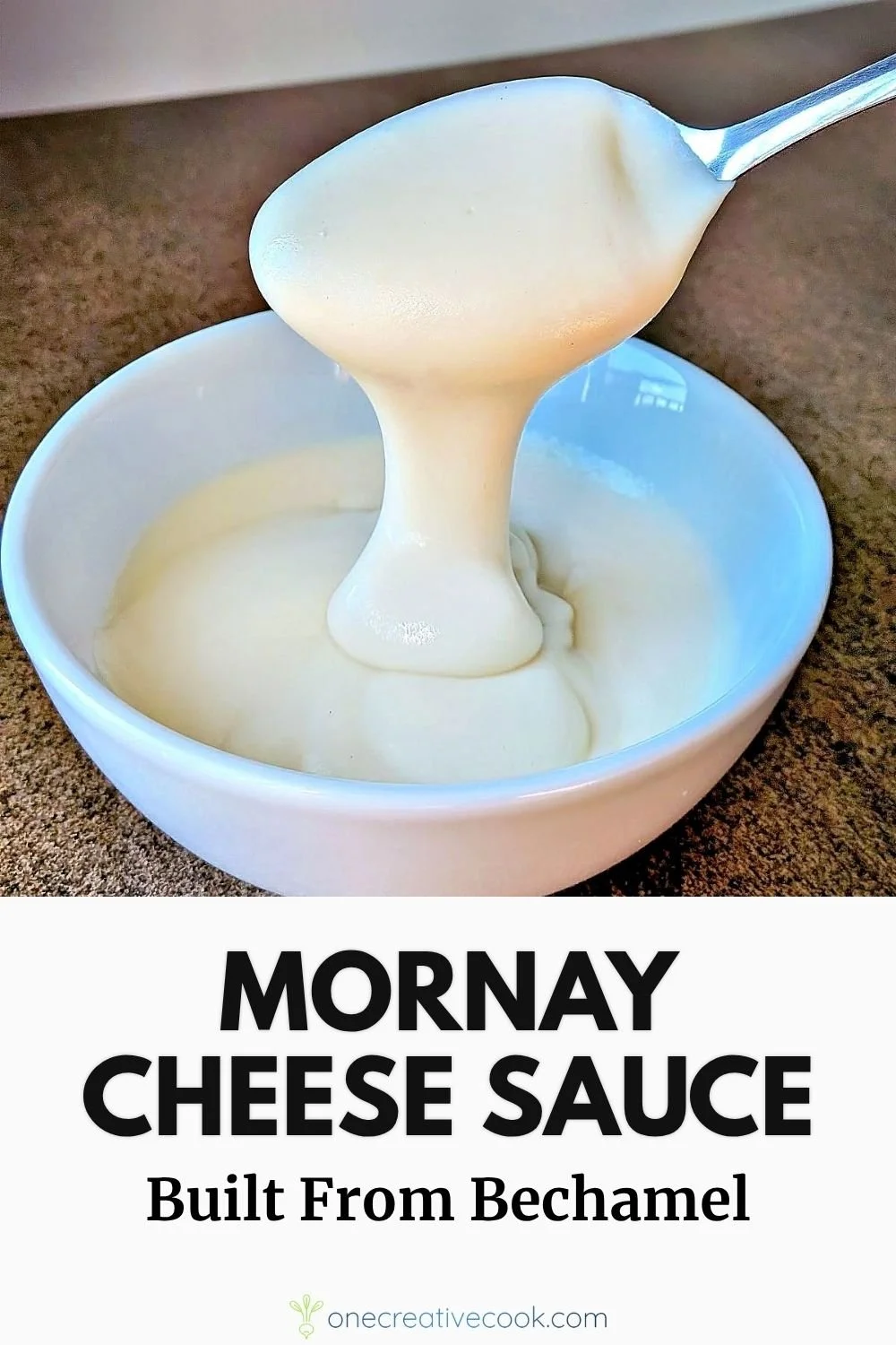 Mornay sauce being drizzled off a spoon into a bowl