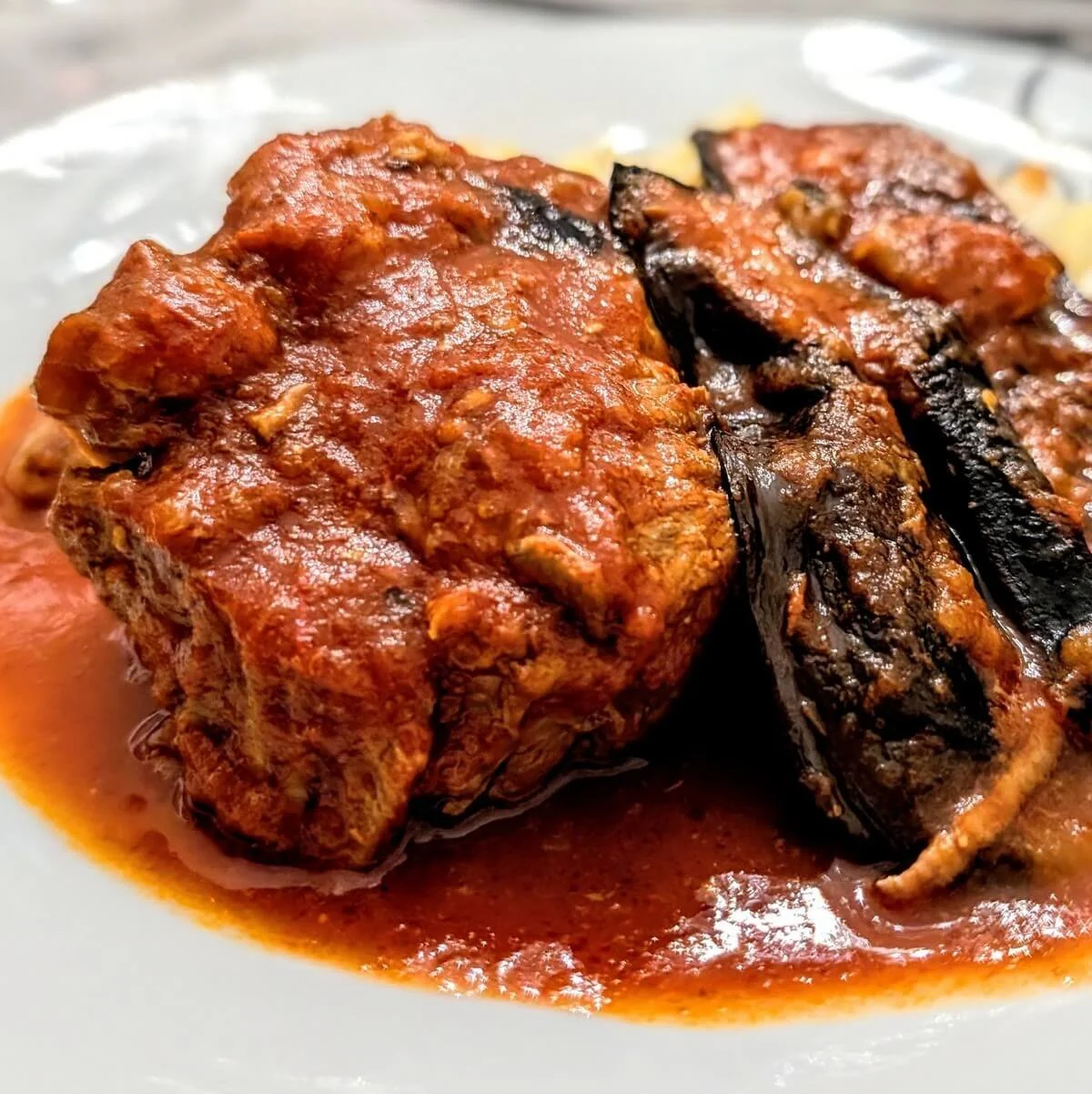 Iraqi lamb and eggplant stew with tender lamb and tomato sauce served over white rice