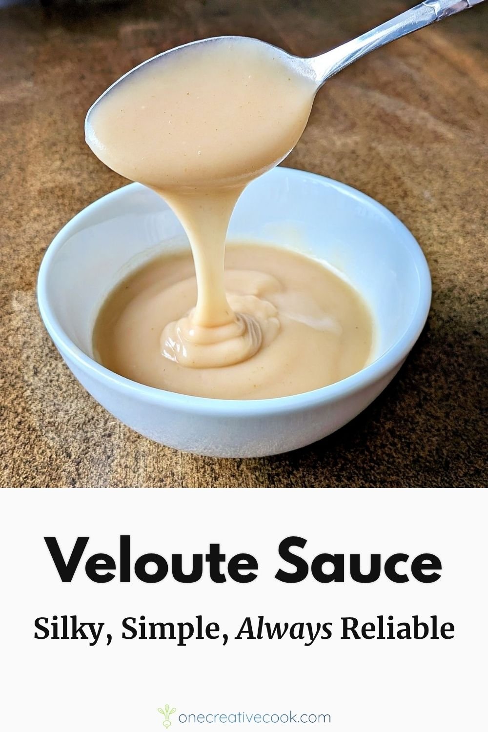 Spoon lifting smooth homemade velouté sauce from a bowl to show its silky consistency