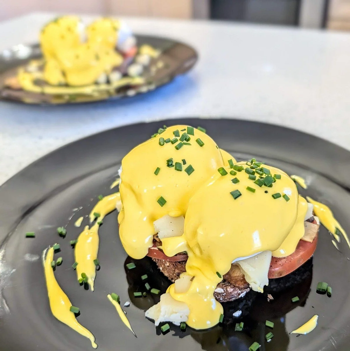 Quick stick blender hollandaise on poached eggs, tomato, cheese, and toast