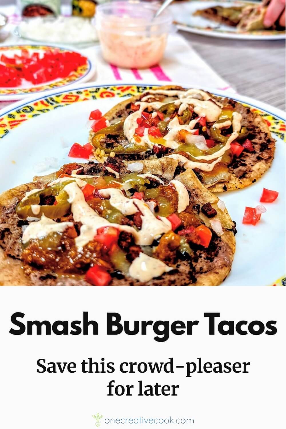 Smash burger tacos recipe with corn tortillas, crispy beef, and Tex-Mex toppings on a plate with fixings in the background