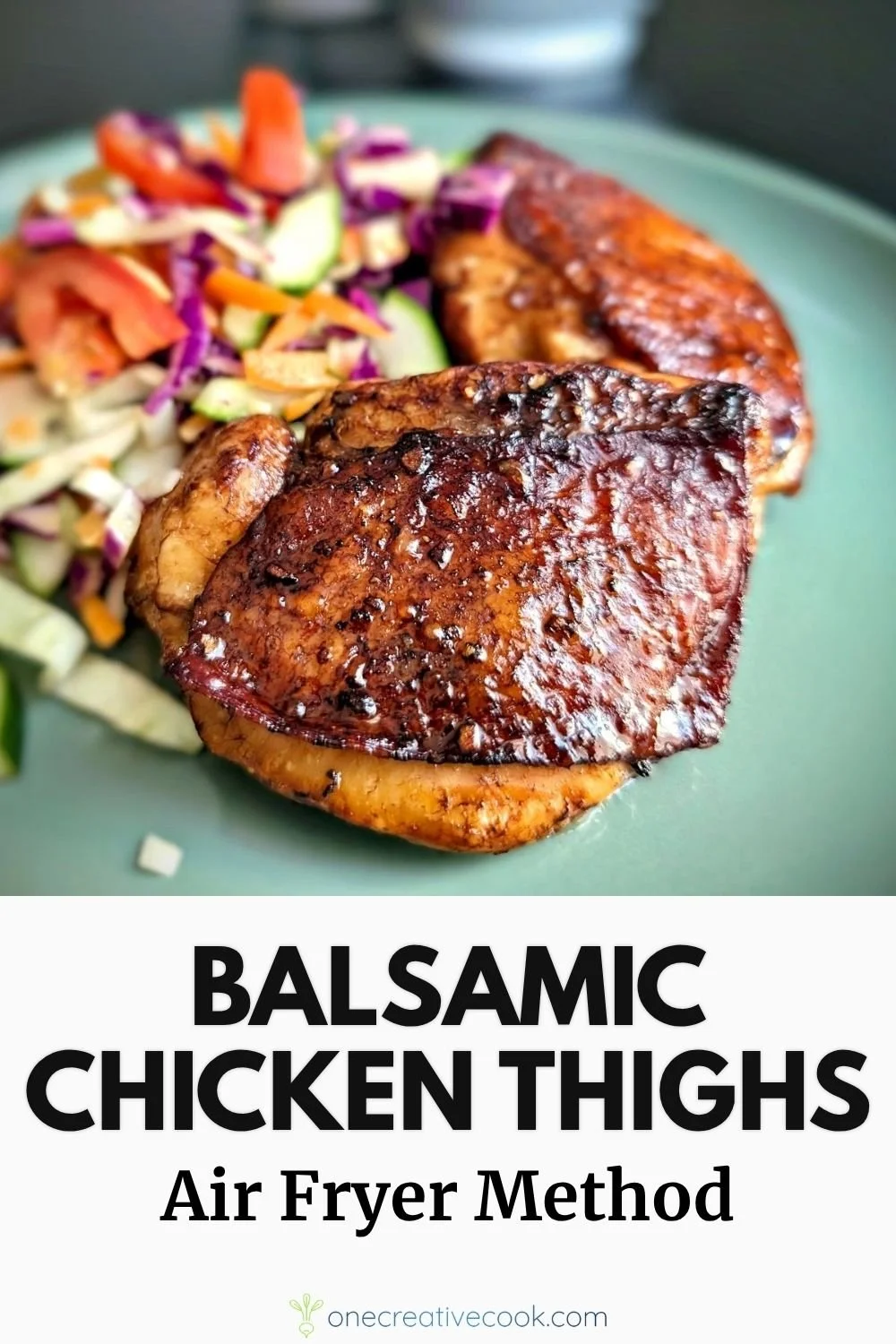 Air fryer balsamic chicken thighs on a plate with salad in the background