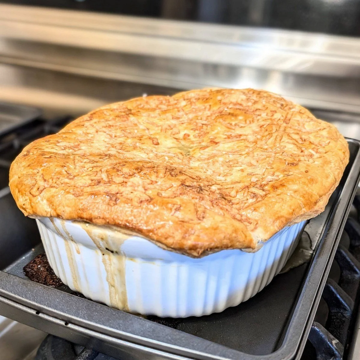 French-style chicken pot pie with gruyere puff pastry crust resting
