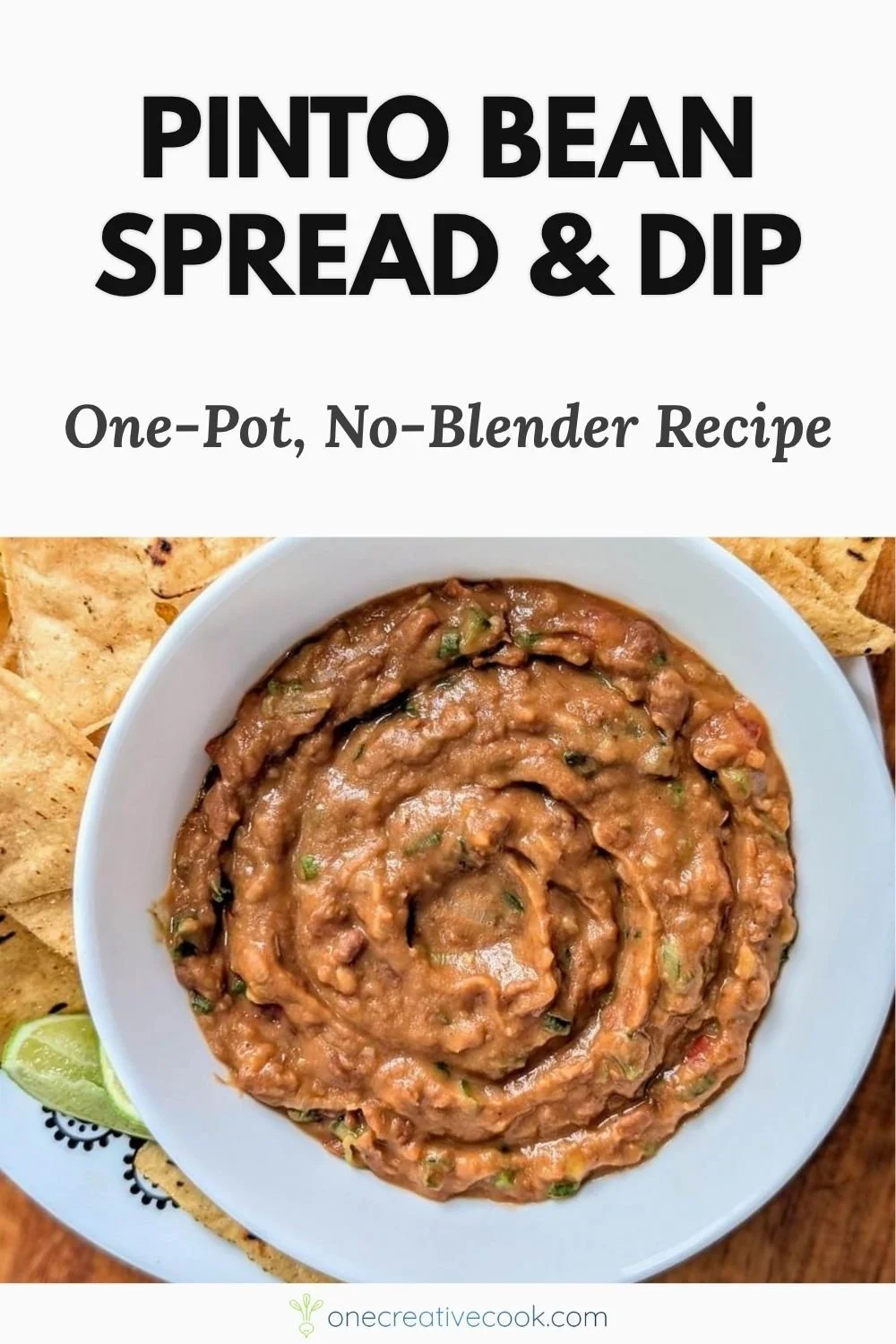 Pinto bean dip in a bowl served with tortilla chips