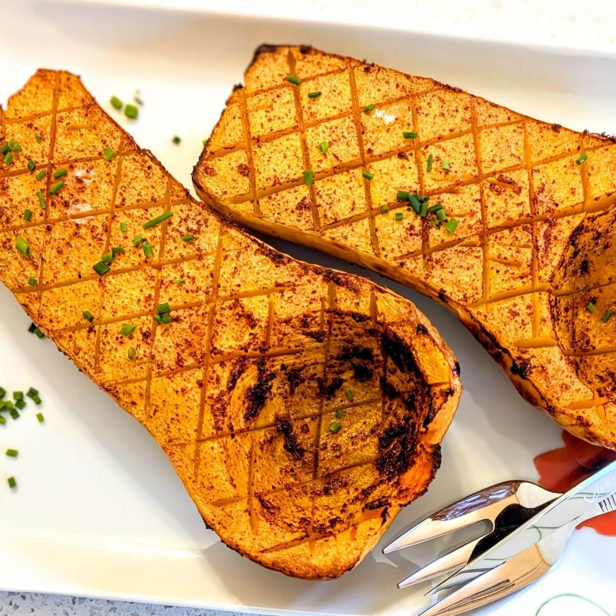 Cross-hatched roasted butternut squash seasoned with sumac and nutmeg on a serving platter, ready for a festive Christmas dinner