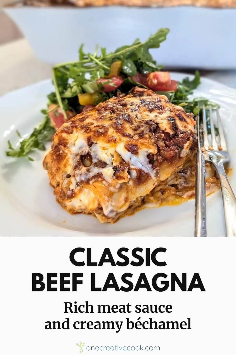 Traditional meat lasagna with bechamel sauce served on a plate with arugula salad