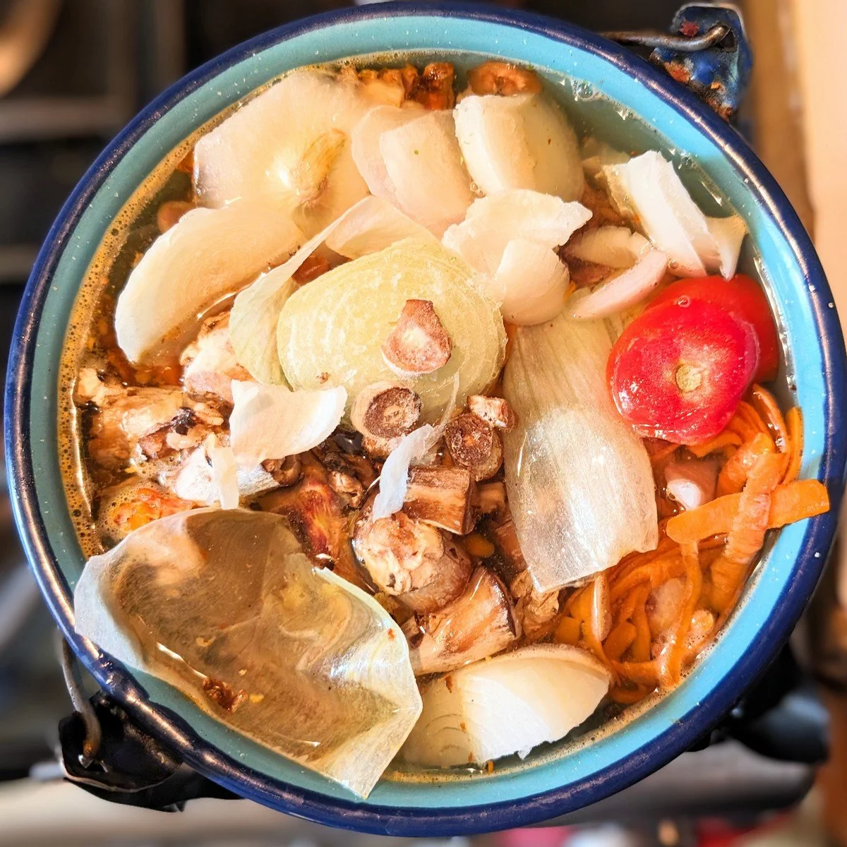 A pot with veggie scraps to make homemade vegetable stock