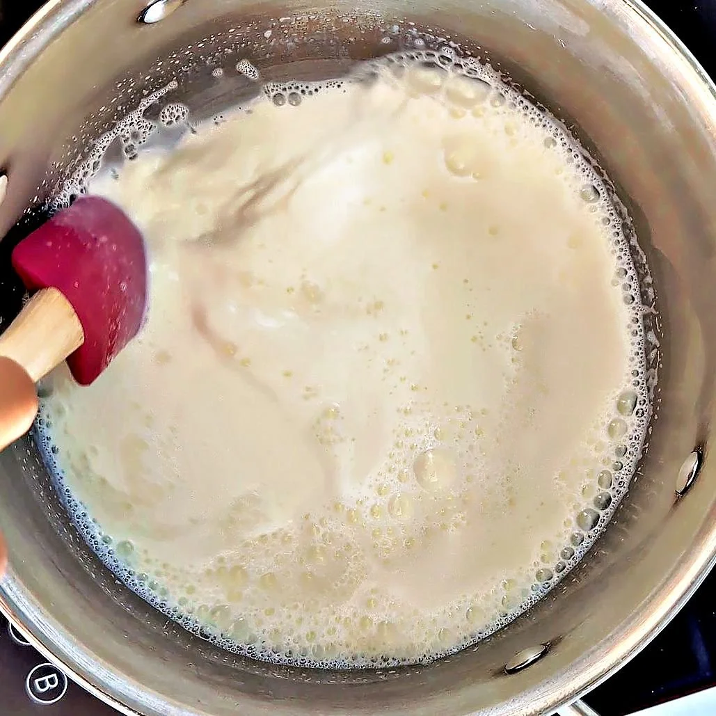 Milk warming in a saucepan for French mornay sauce