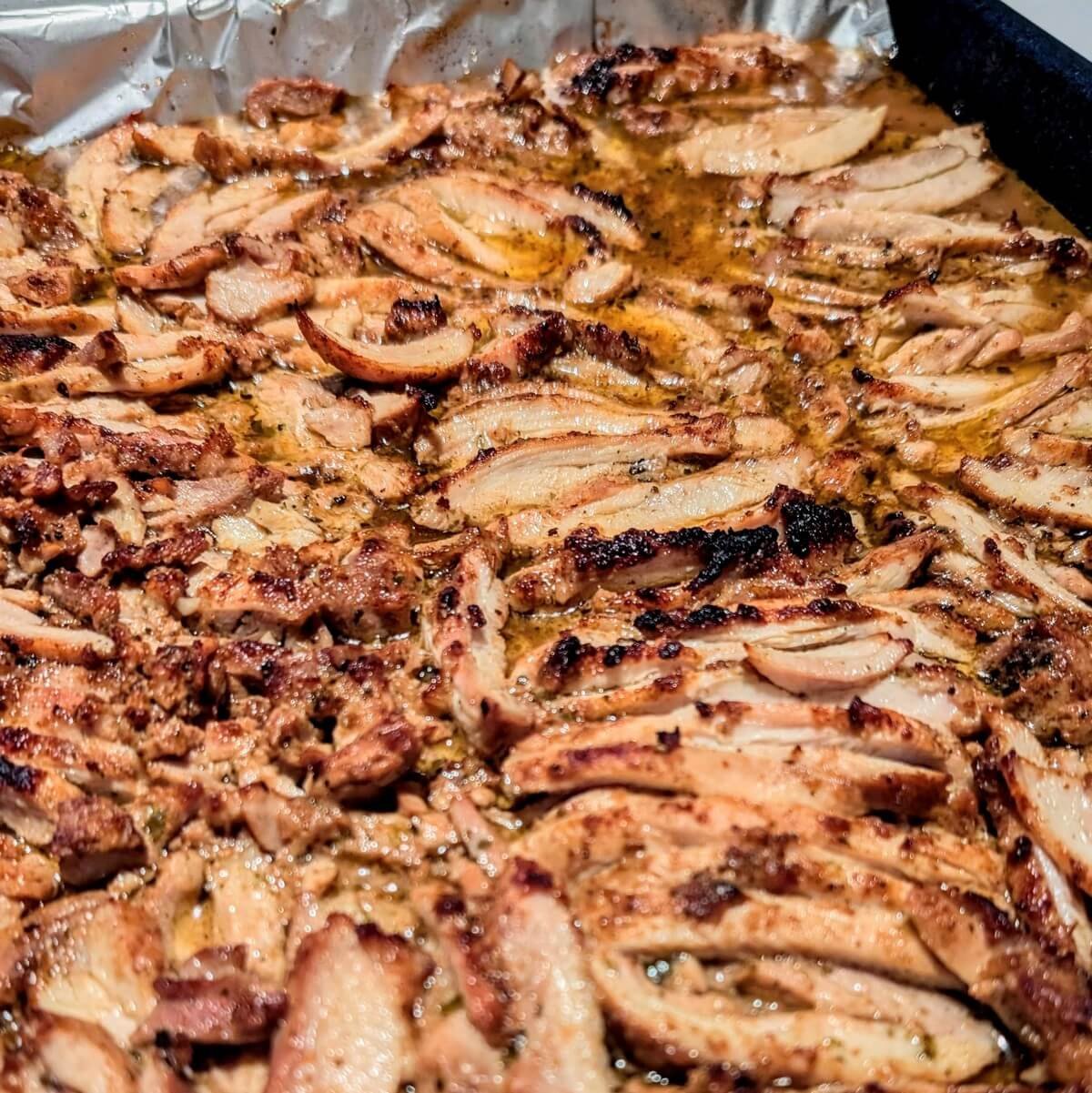 Homemade chicken shawarma on a sheet pan with charred and crispy edges