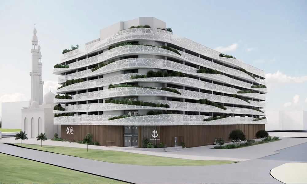 Modern multi-story building with curved balconies and lush greenery, located near a mosque.
