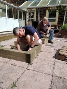 Simon and Eugene put the first layer of the new raised bed together